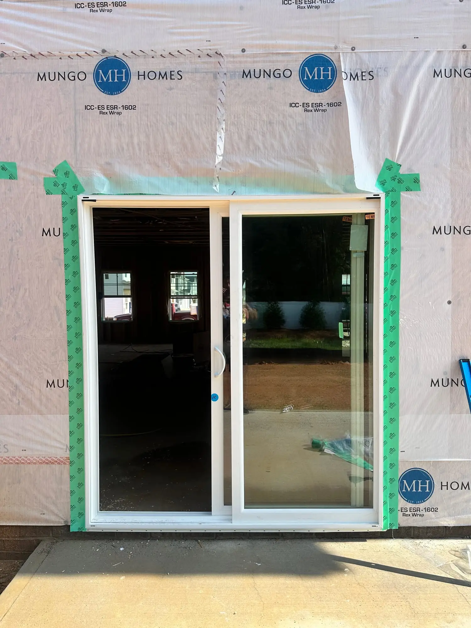 Sliding glass patio door installed in a new home before siding goes on