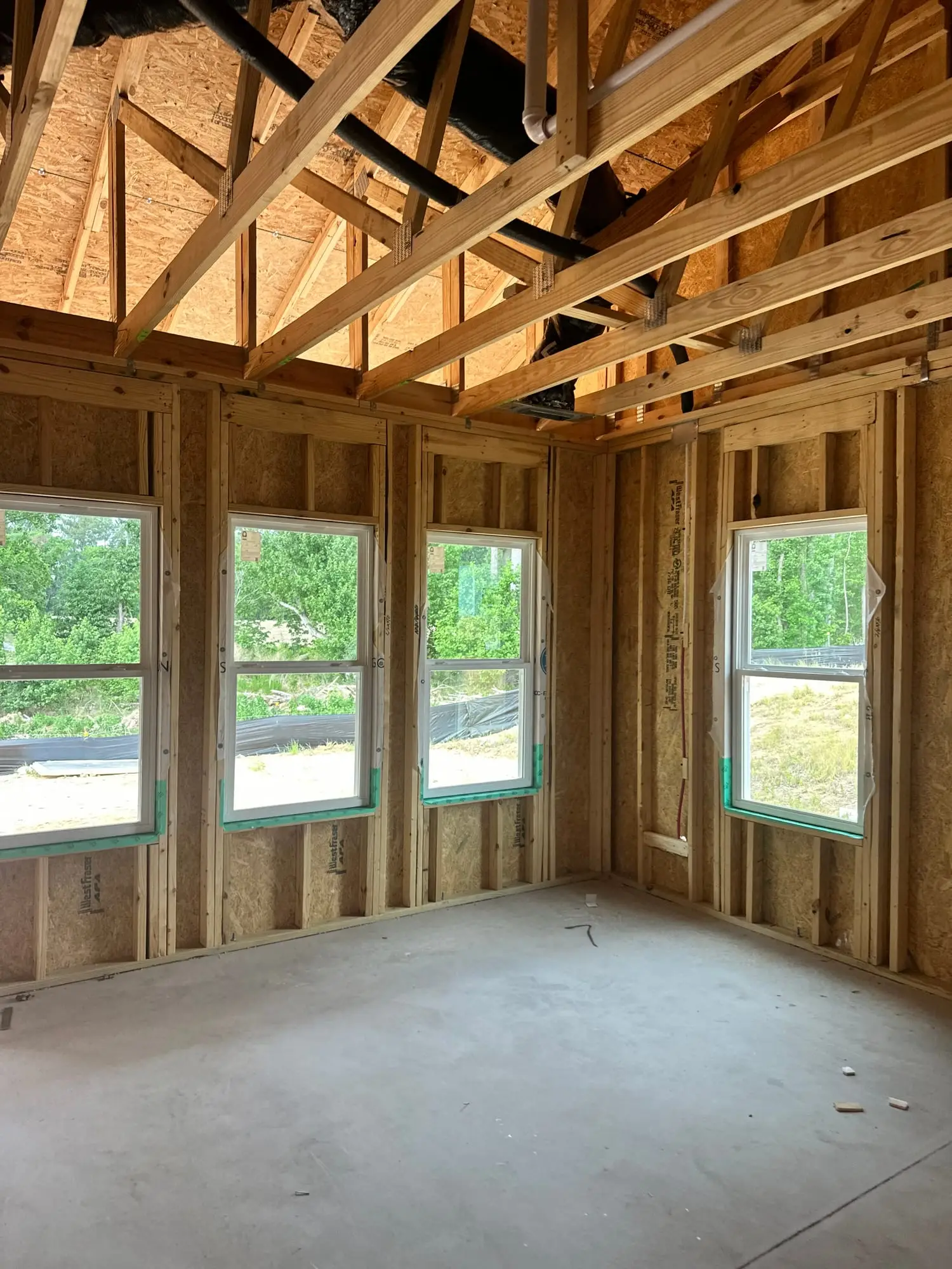 New windows seen from inside a framed room on a new build