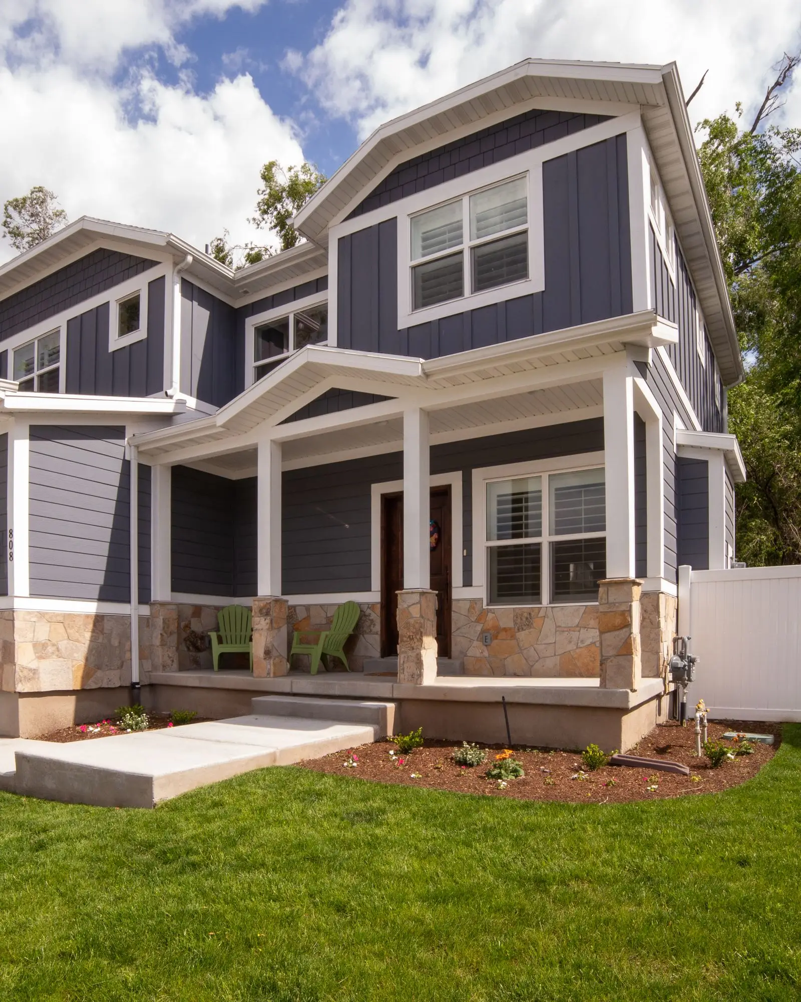A bright navy craftsman-style home with a front porch, the kind JND Home Solutions works on
